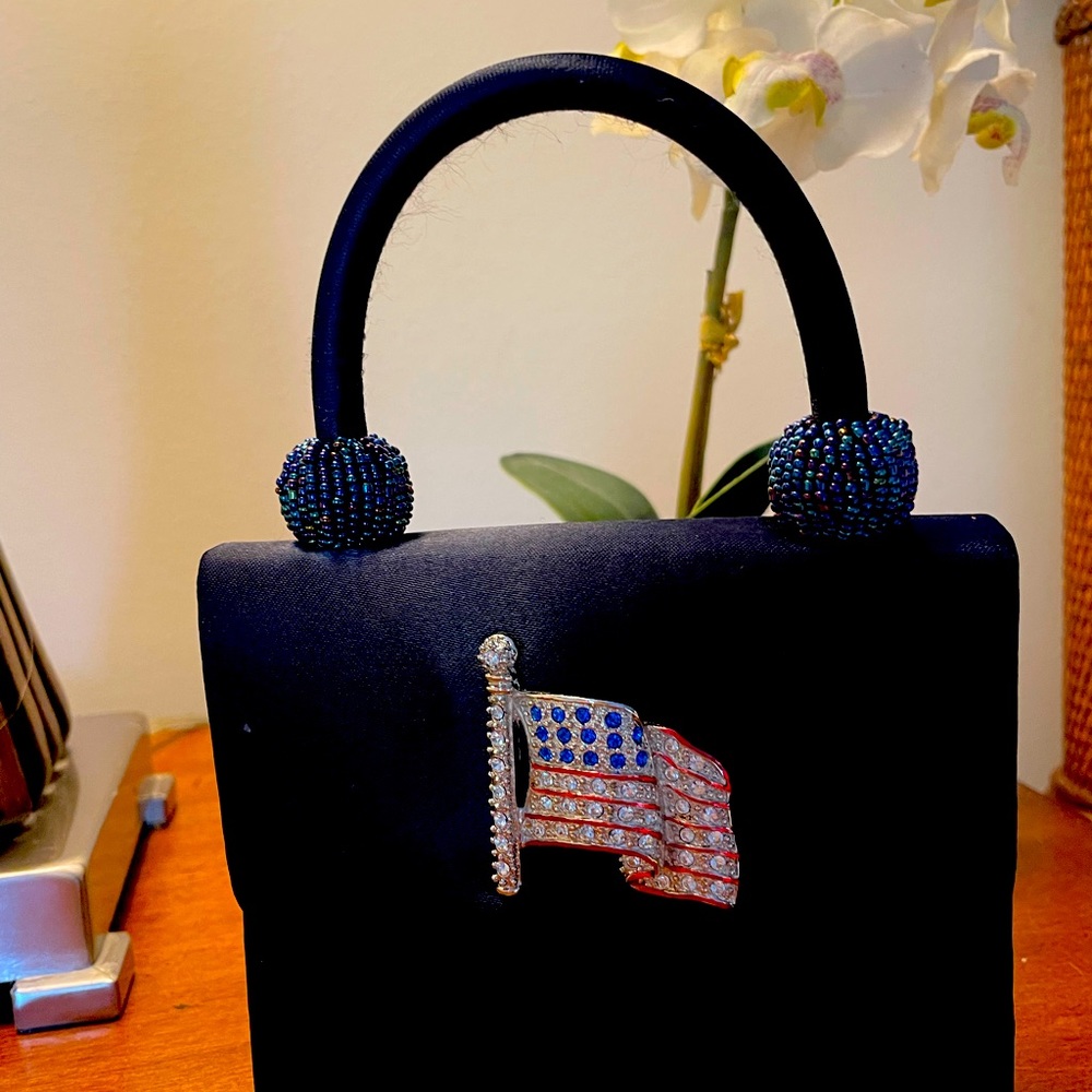 Elegant navy satin evening bag with American flag rhinestone brooch.